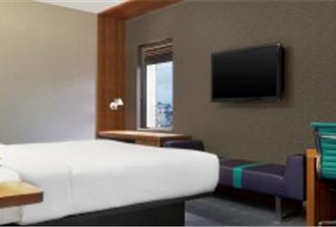 Young (business) travelers just want a clean and efficient space to stay. They spend less time in rooms and like to socialize and work in vibrant lobbies with a sense of community. That is why Hilton’s new Tru brand offers chairs with large arm rests instead of desks.